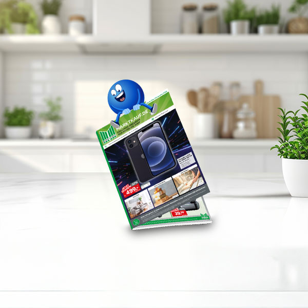 Werbeprospekt mit Angeboten, auf einem Küchentisch mit Pflanzen im Hintergrund.